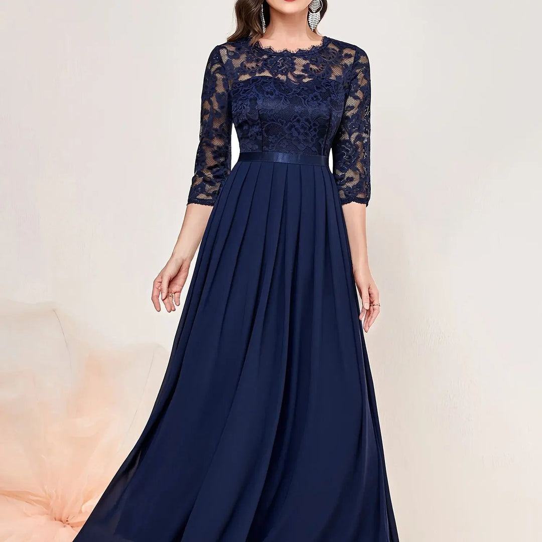 Navy lace bodice maxi dress close-up showing satin belt and pleated skirt