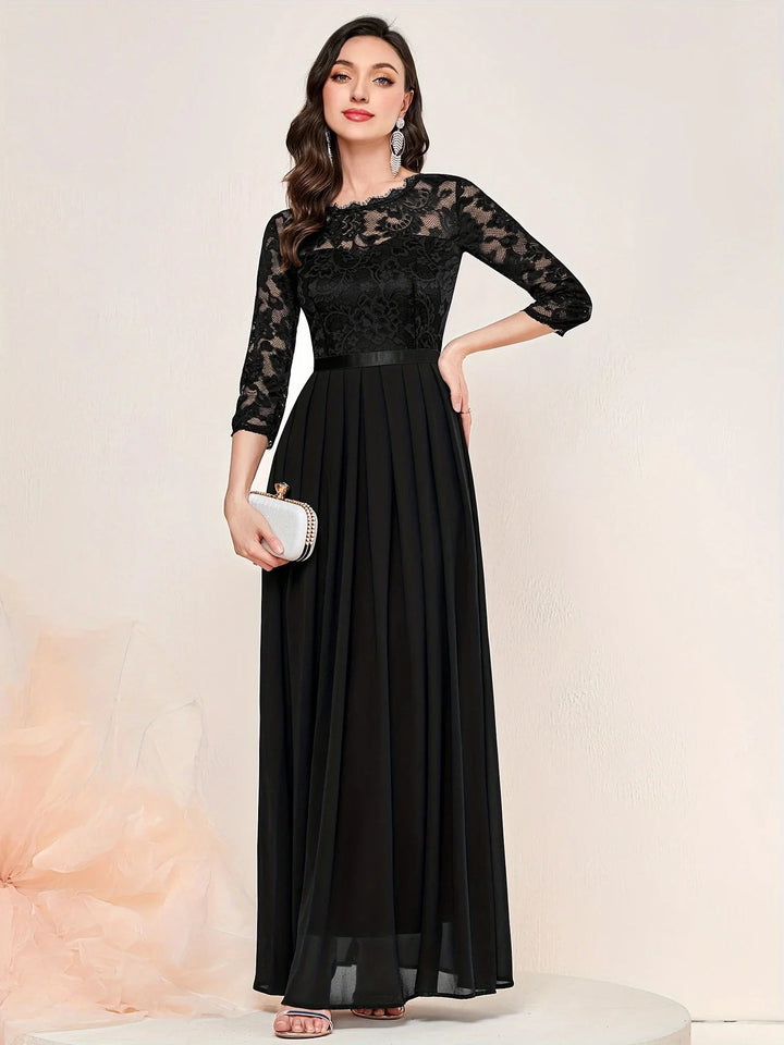 Black lace evening gown with sheer sleeves and satin-trimmed pleated skirt