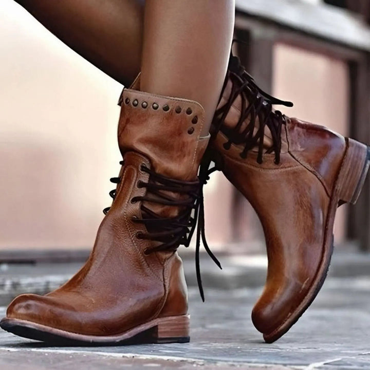 Close-up of brown leather lace-up ankle boots with stacked block heel