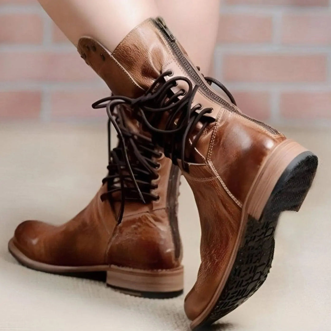 Rear view of tan leather lace-up boots showing side zip and heel detail