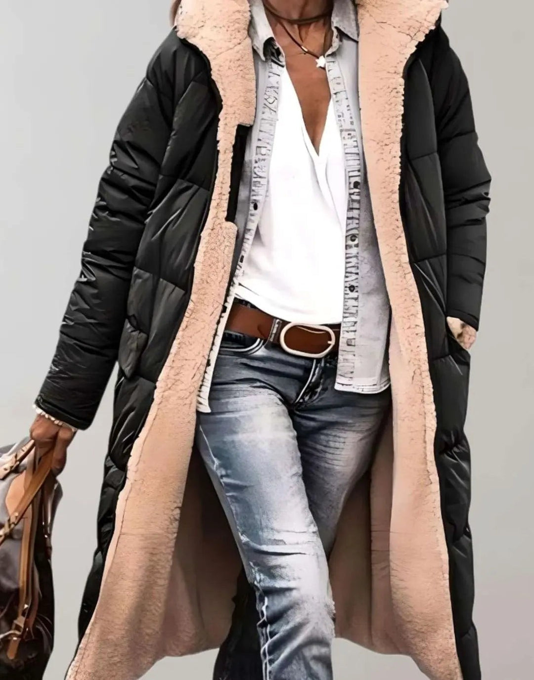 Black quilted longline coat featuring plush cream fleece hood lining