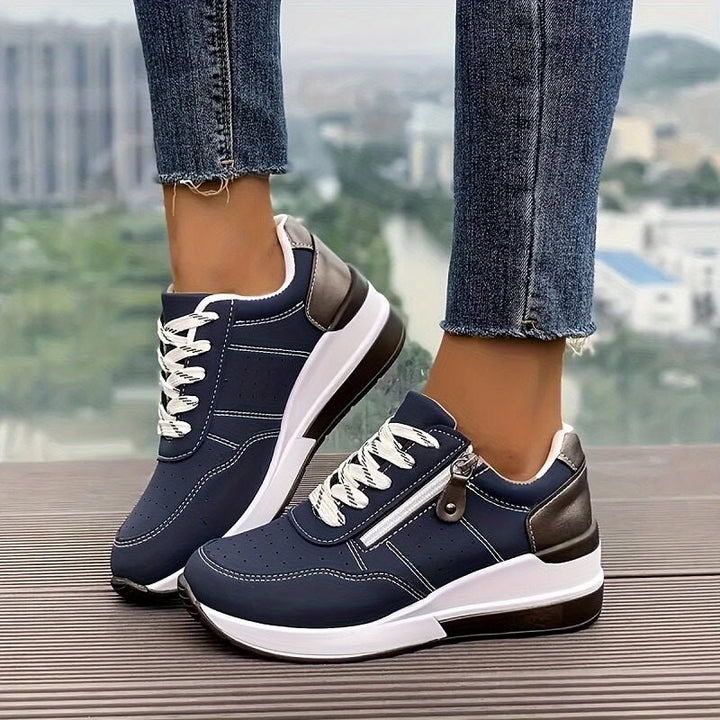 Navy lace-up trainers with white wedge sole and zip side detail