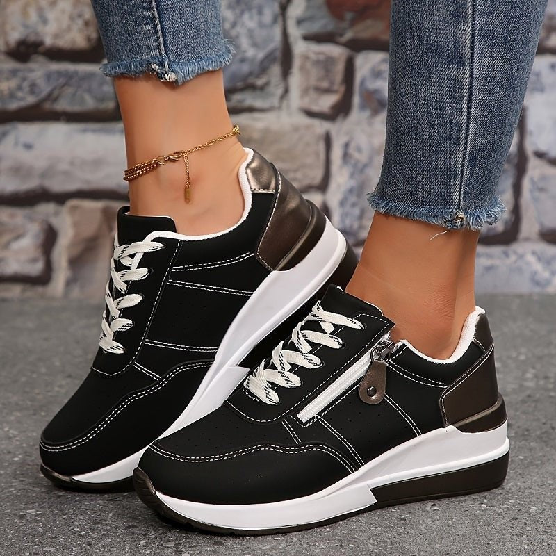 Black lace-up trainers with metallic heel trim and zip fastening