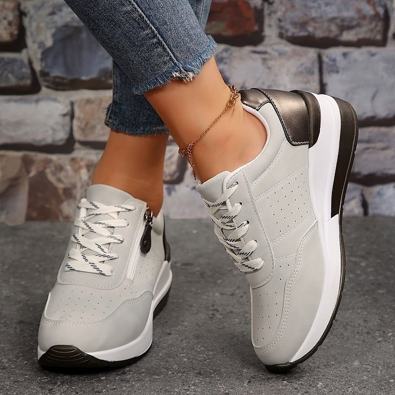 Light grey lace-up trainers with contrasting dark heel panel