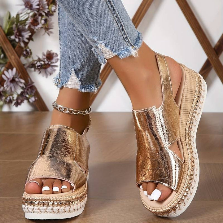 Rose gold metallic wedge sandal with chain ankle strap and woven platform