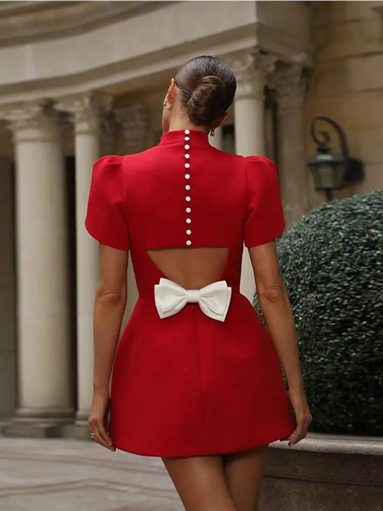 Red cocktail dress back view showing pearl buttons and bow tie fastening