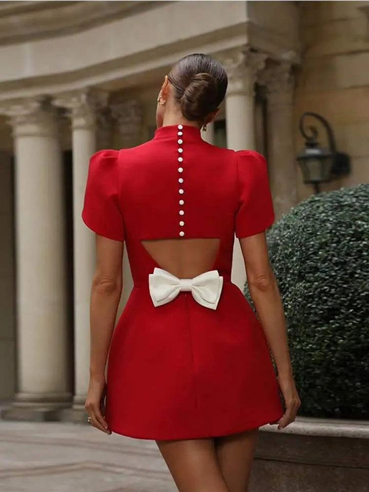 Red cocktail dress back view showing pearl buttons and bow tie fastening