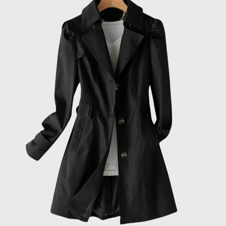 Black trench coat featuring tortoiseshell buttons and tailored waist
