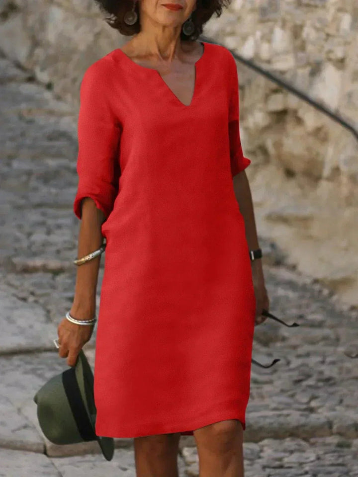 Red V-neck midi dress with mid-length sleeves and a relaxed shift cut