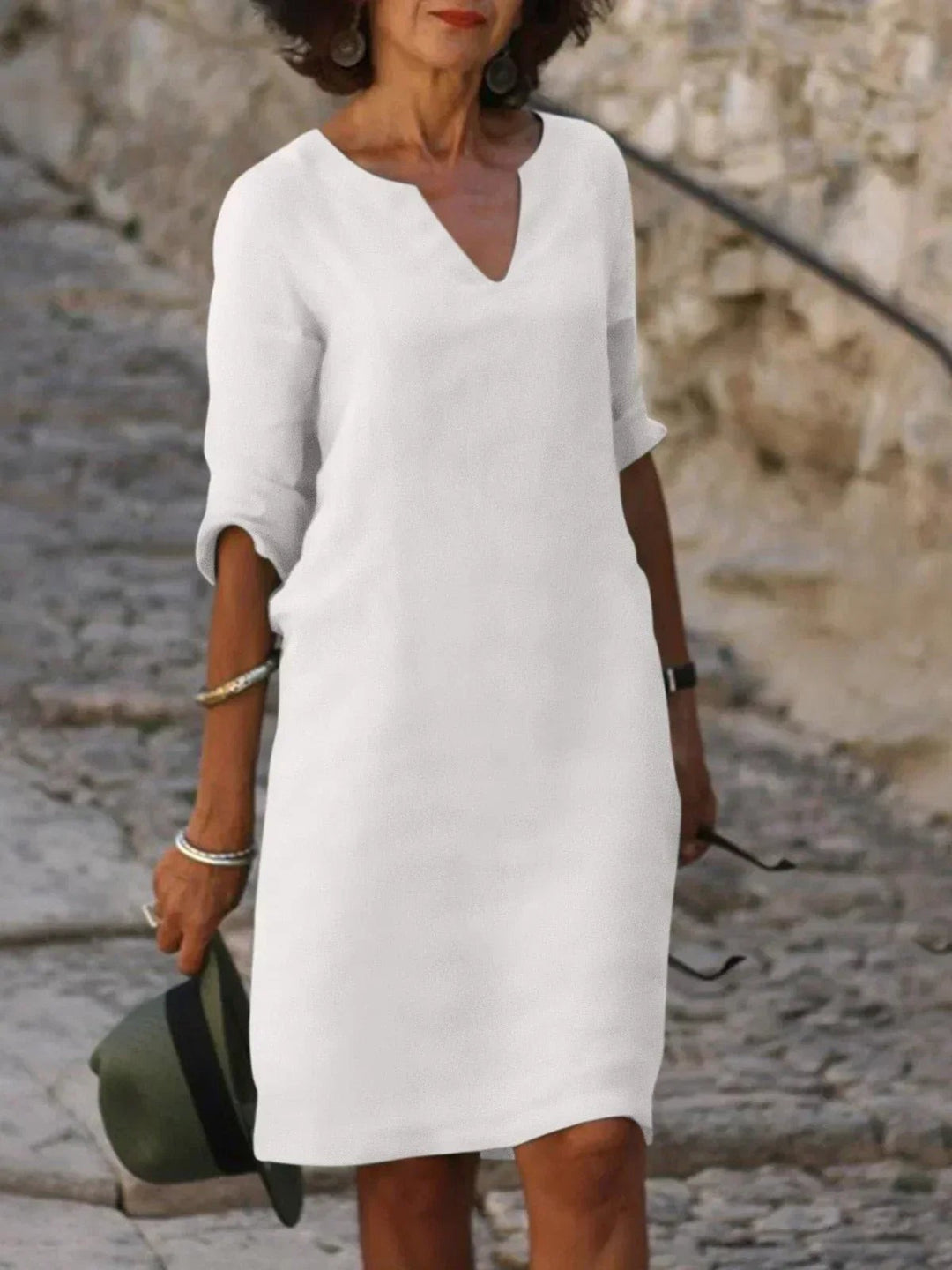 White notch-neck shift dress featuring mid sleeves and a knee-length hem