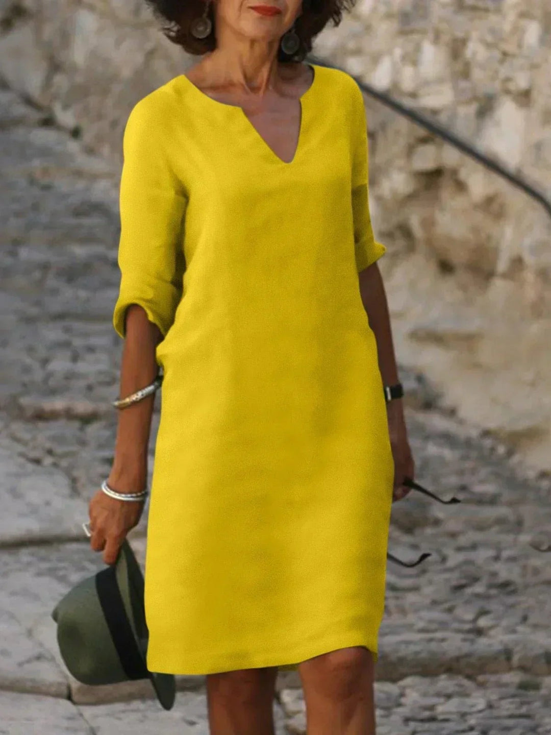 Bright yellow V-neck midi dress with mid-length sleeves and relaxed shape