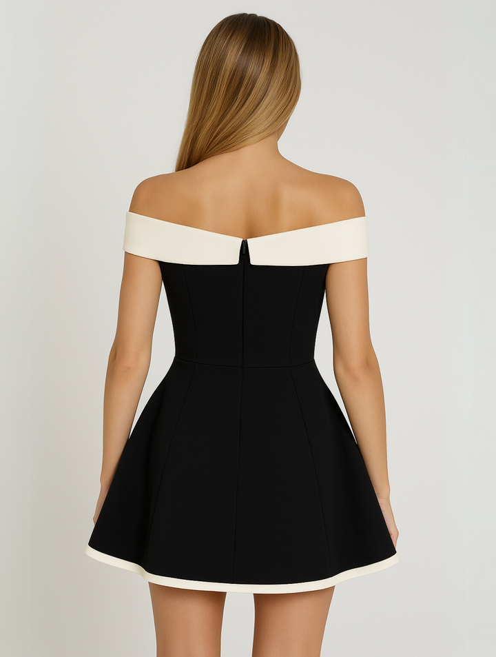 Rear view of black off-shoulder mini dress showing cream trim and zip fastening