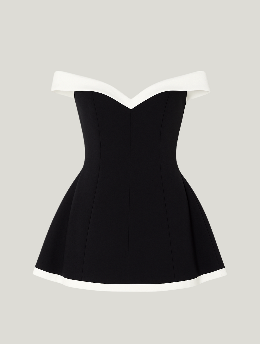 Flat lay of black fit-and-flare mini dress with contrasting cream hem and neckline