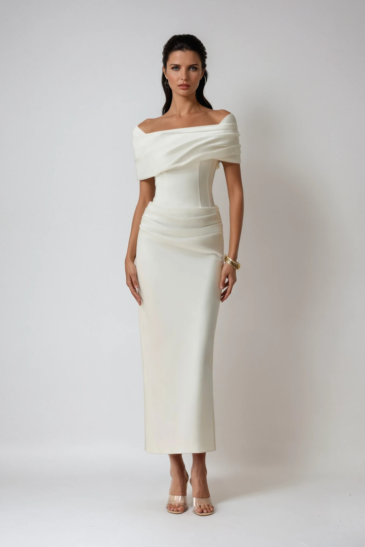 Model showcasing fitted ivory maxi dress with draped off-shoulder design