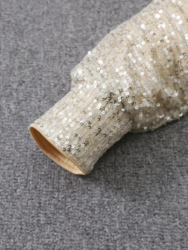 Close-up of cream sequin sleeve cuff with lining detail