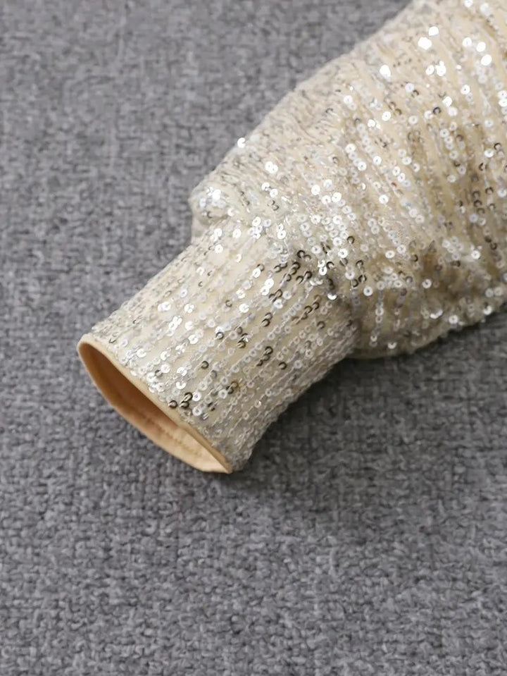 Close-up of cream sequin sleeve cuff with lining detail