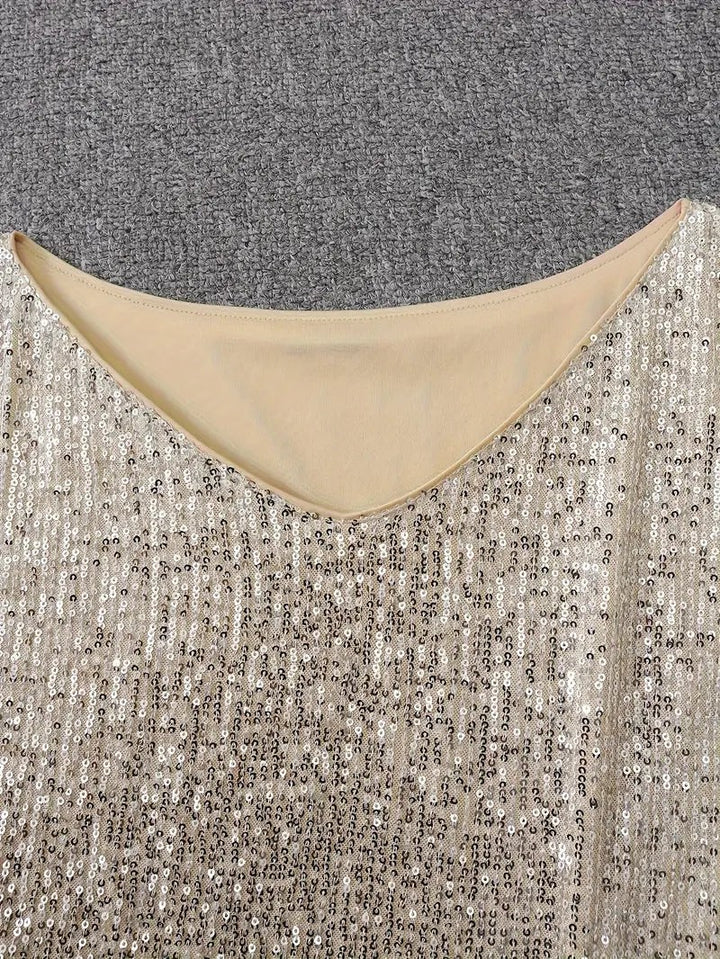 Close-up of cream sequin dress neckline with nude lining trim
