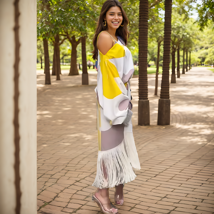 One-shoulder midi dress showing draped waist tie and tasselled skirt hem