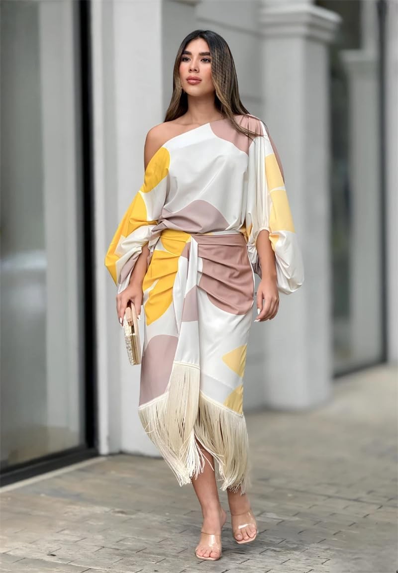 Side view of asymmetric midi dress highlighting billowing sleeve and fringed skirt