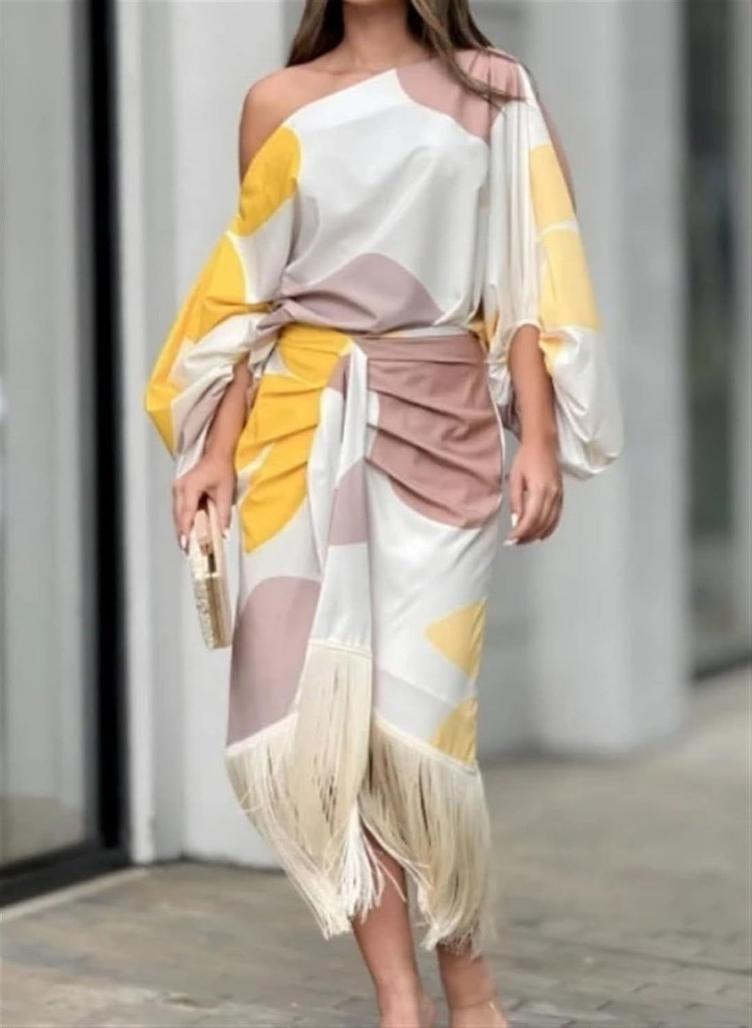 One-shoulder satin midi dress in abstract print, worn with a gold clutch