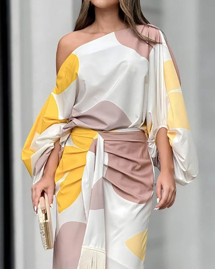 Close-up of batwing sleeves and ruched waist tie on printed midi dress