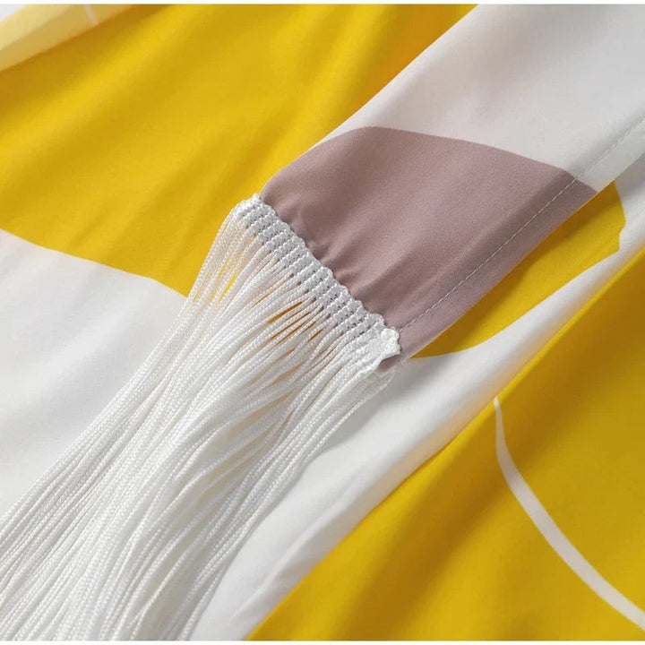 Fringed hemline detail on abstract print midi dress with clear heels