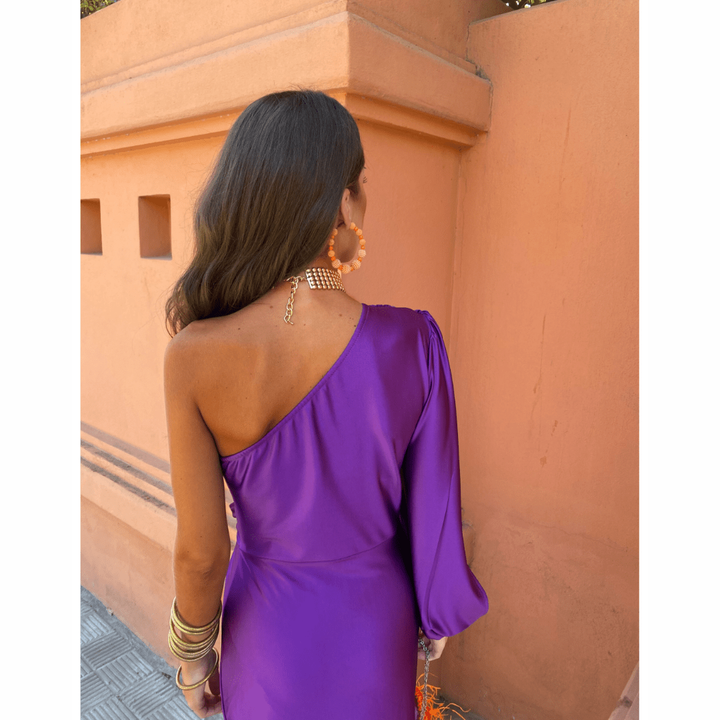 Back view of purple satin one-shoulder dress with billowing long sleeve
