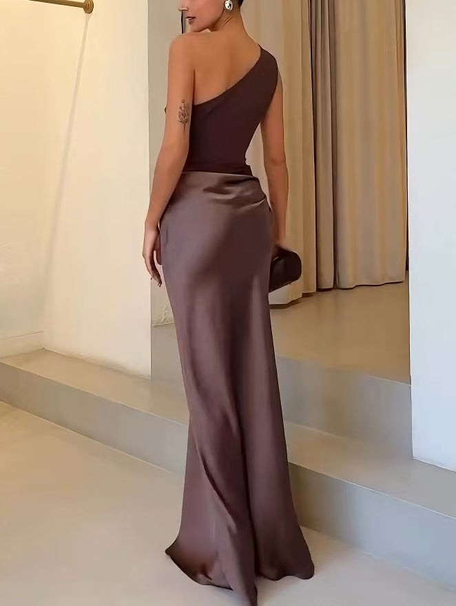 Side view of brown one-shoulder maxi dress with smooth satin skirt