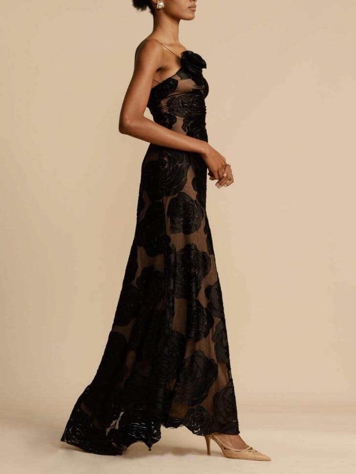 Side view of black rose print maxi dress with sheer panels