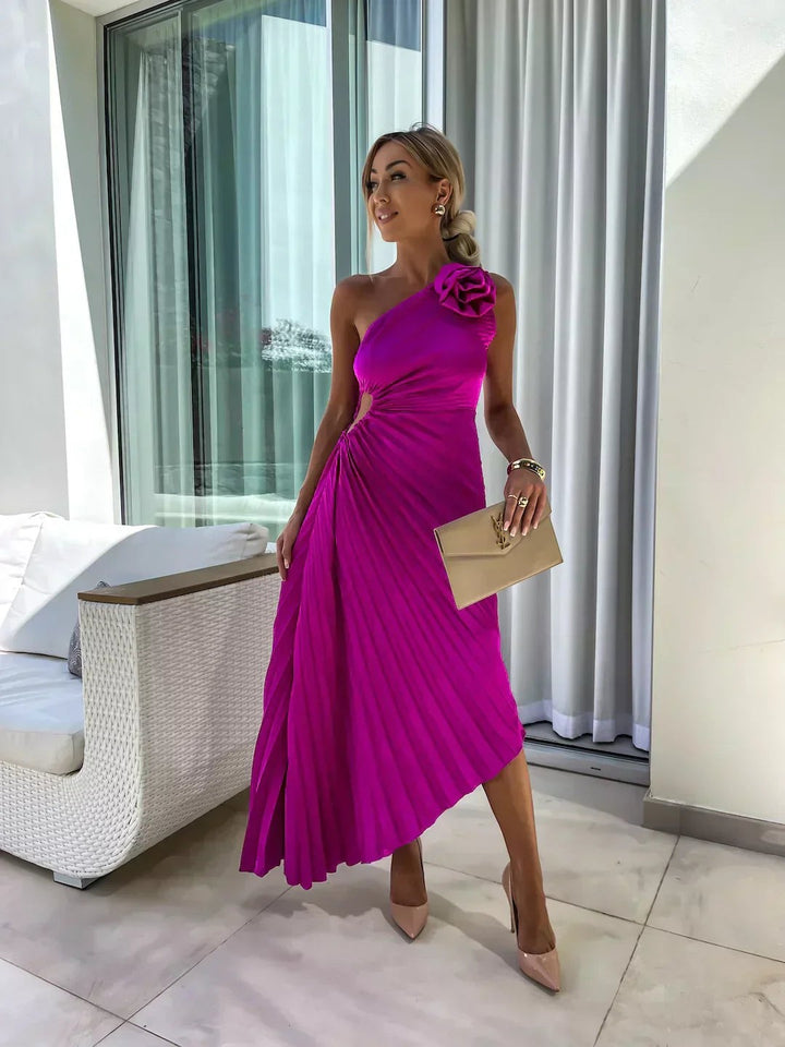 Magenta pleated one-shoulder dress with rosette detail and asymmetric skirt