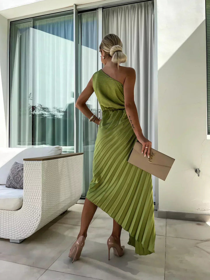 Rear view of olive pleated one-shoulder dress with draped asymmetric skirt