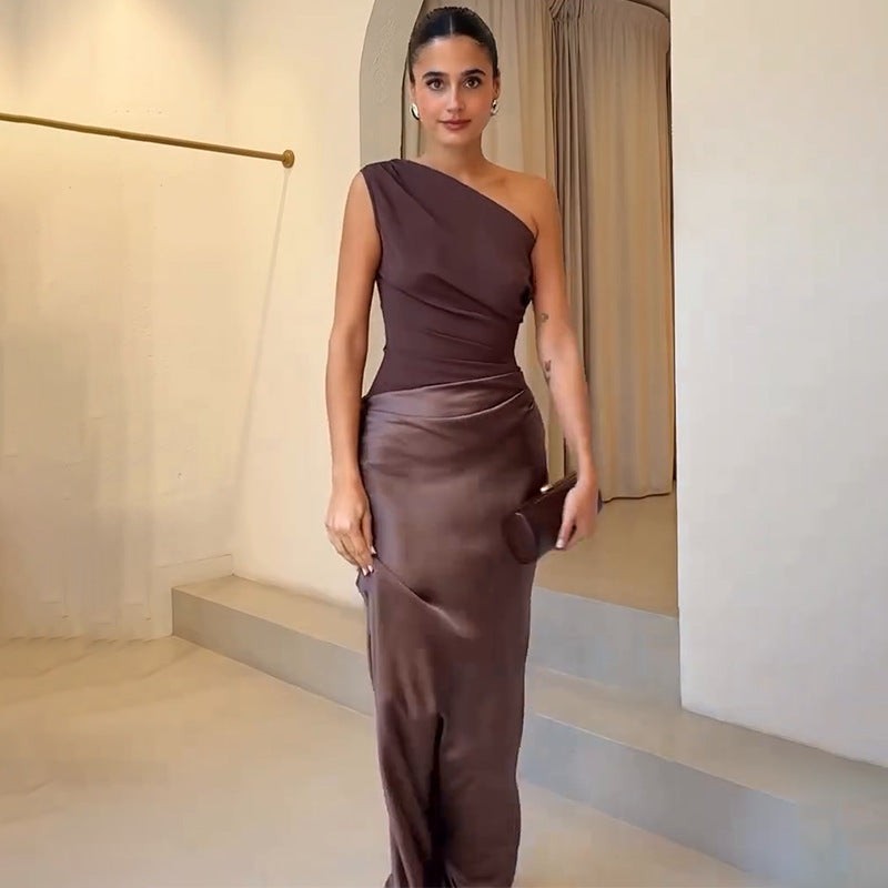 Chocolate brown draped one-shoulder gown paired with structured clutch