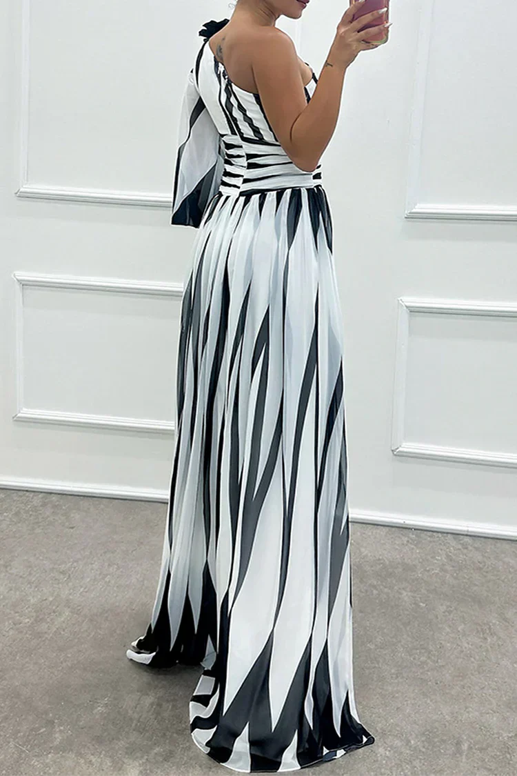 Rear view of striped one-shoulder maxi dress with cinched waist and flared skirt