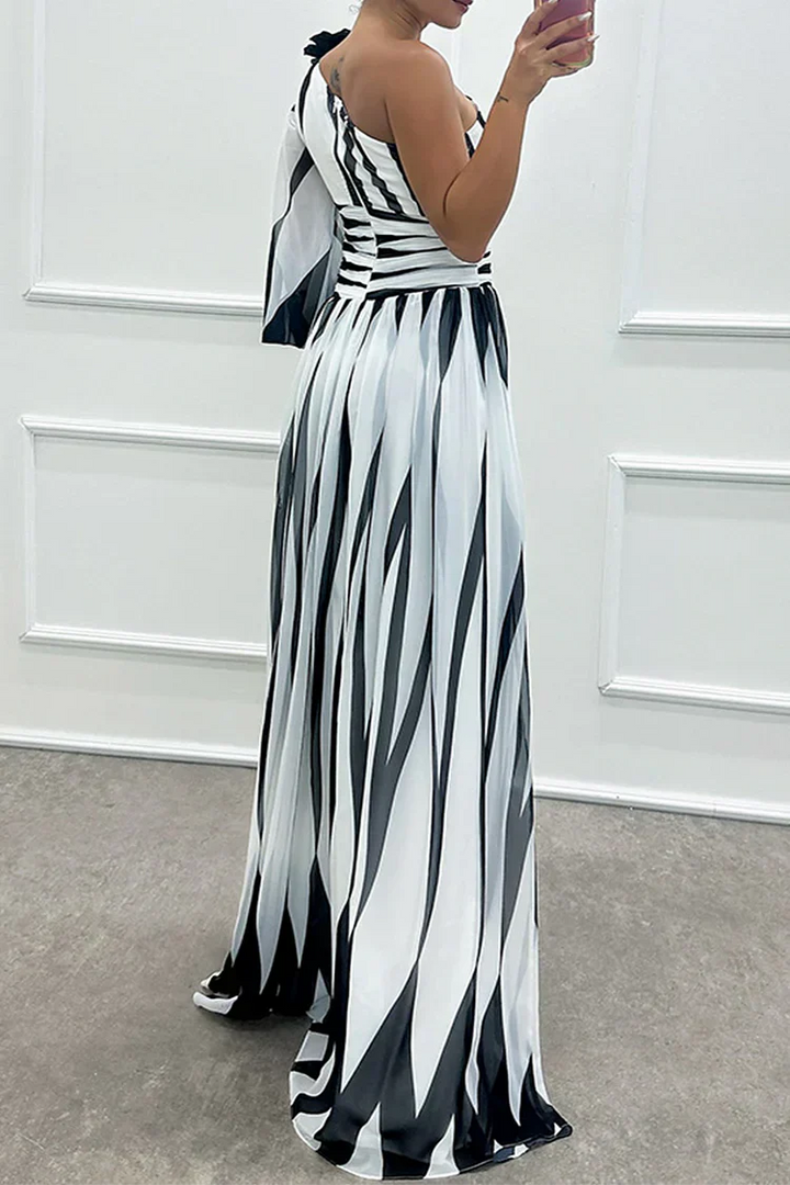 Rear view of striped one-shoulder maxi dress with cinched waist and flared skirt