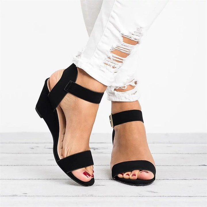Black suede wedge sandals with ankle strap and open toe design