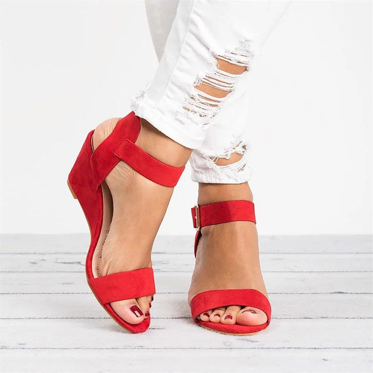 Red suede ankle strap wedge sandals with open toe and buckle