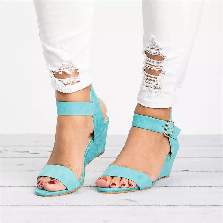 Turquoise suede wedge sandals with open toe and adjustable ankle strap