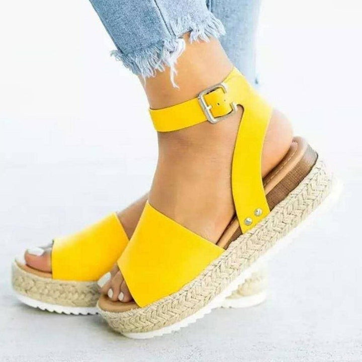 Yellow ankle-strap wedge sandals featuring buckle fastening and espadrille sole