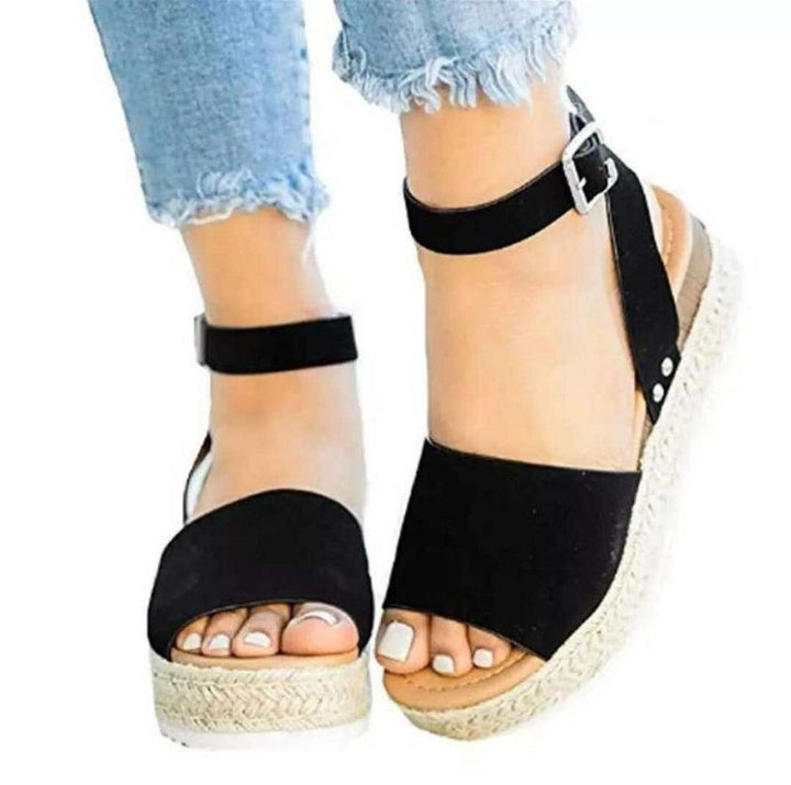 Black open-toe wedge sandals with ankle strap and braided platform