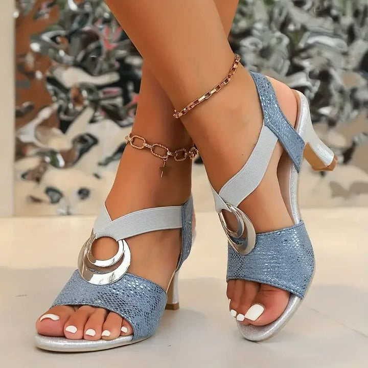 Blue snake-print heeled sandals with silver ring buckle and crossover straps