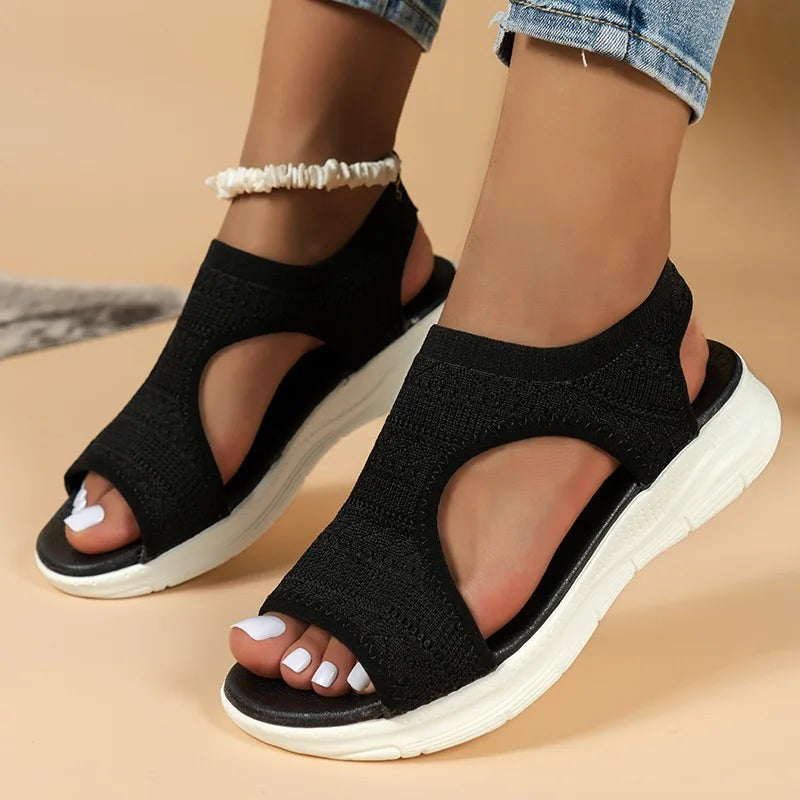 Black knitted open-toe sports sandals with cut-out sides and thick white sole