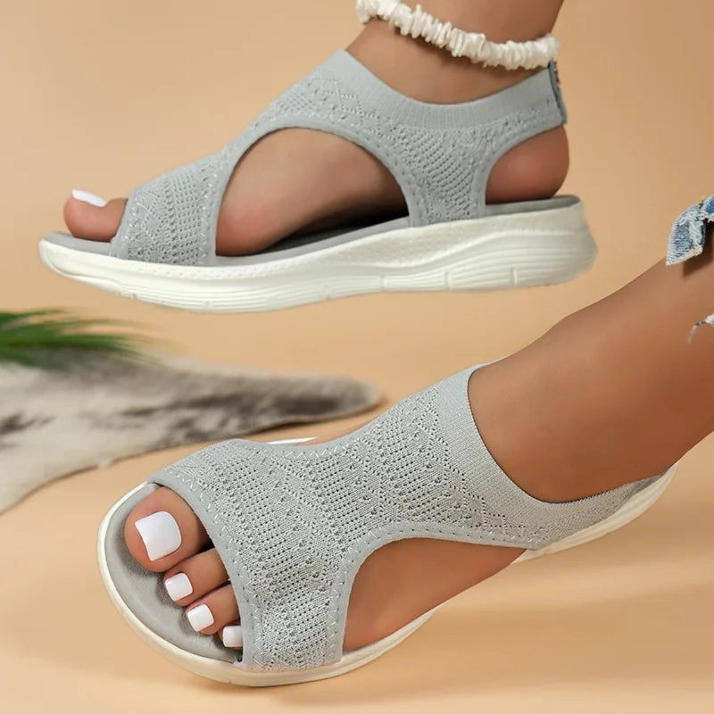 Grey knitted flat sandals with peep toe, cut-out sides and ridged white sole