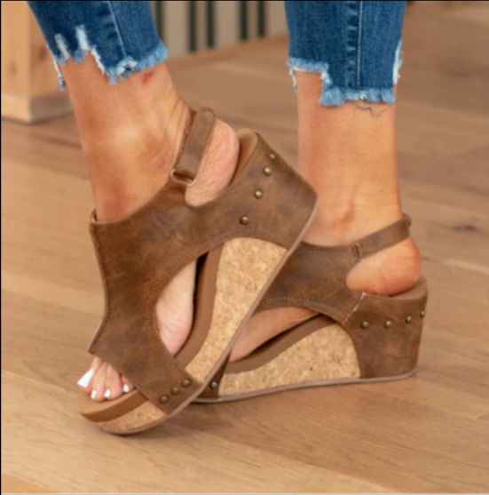 Tan leather wedge slingback sandals featuring cork heel and cut-out sides