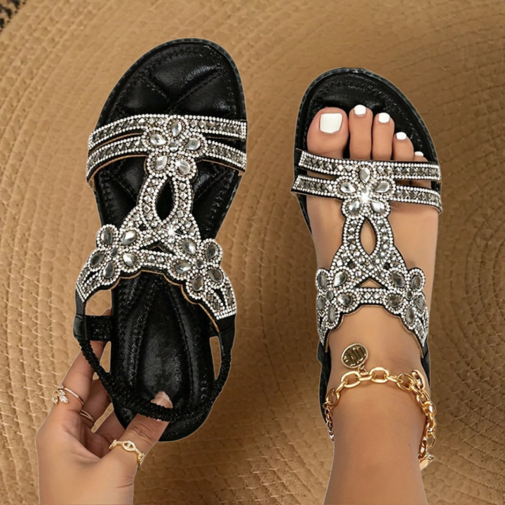 Silver metallic flat sandals with crystal-embellished straps and cushioned footbed