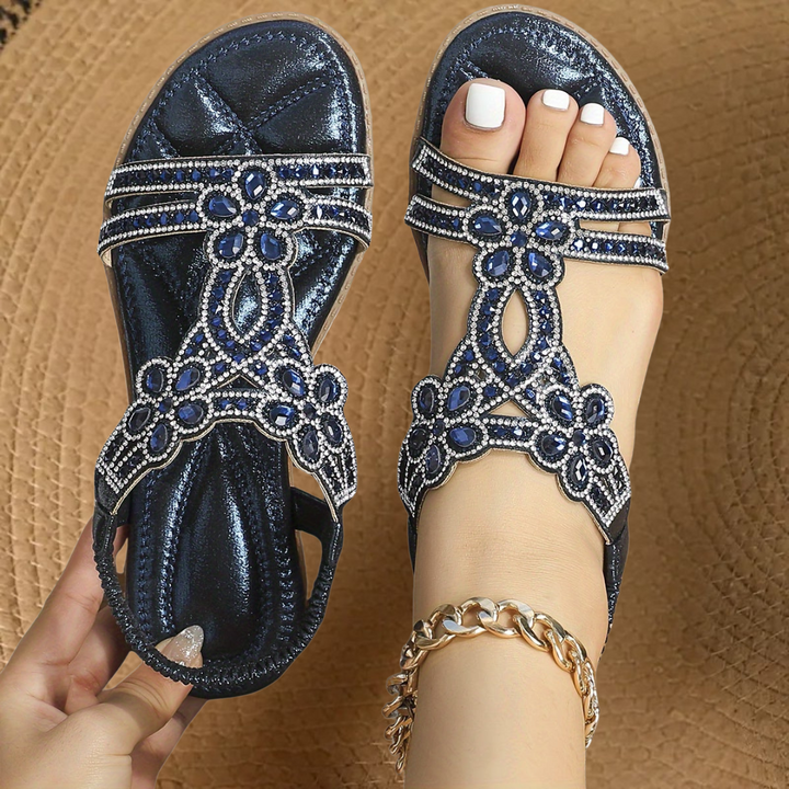 Gold metallic flat sandals with sparkling crystal straps and elasticated heel band