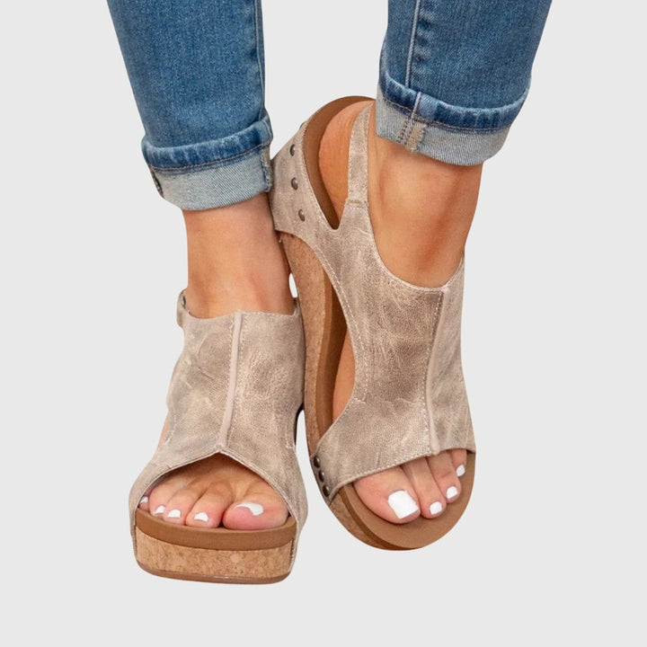 Beige studded slingback wedge sandals featuring cork platform and open toe design
