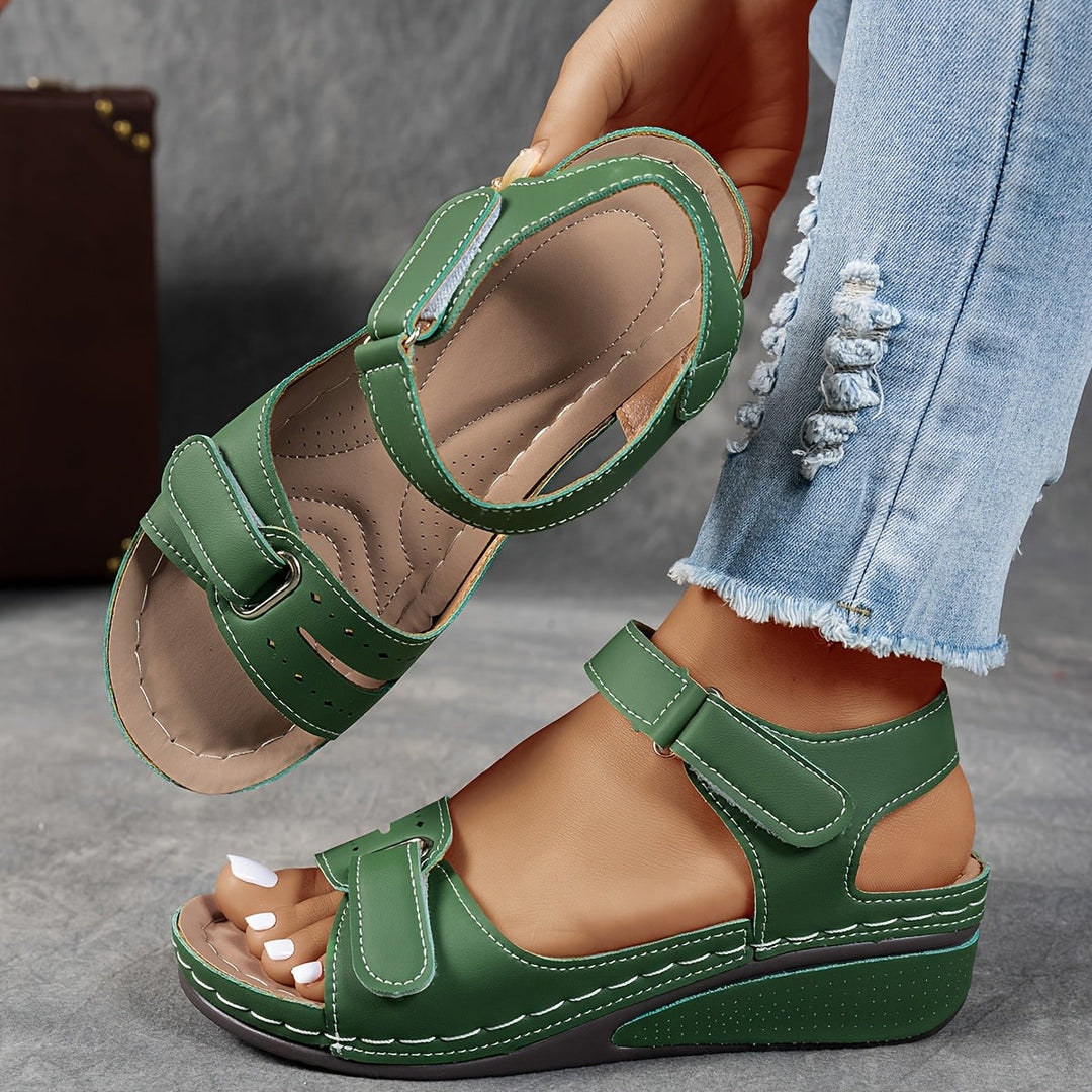 Olive green wedge sandal showing contrast stitching and orthopedic-style footbed