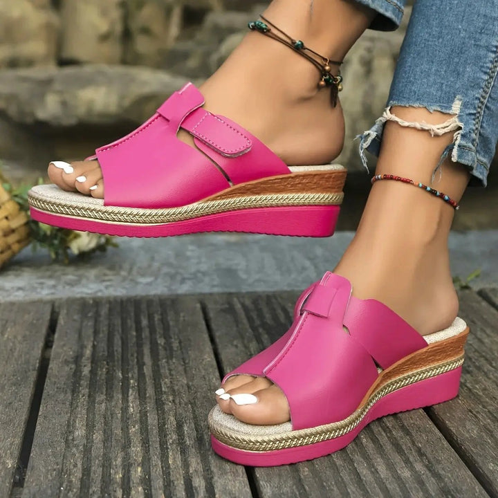 Hot pink open-toe wedge sandal with woven espadrille sole and touch-strap fastening