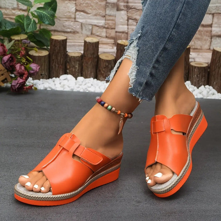 Navy blue open-toe wedge sandal with adjustable strap and espadrille platform
