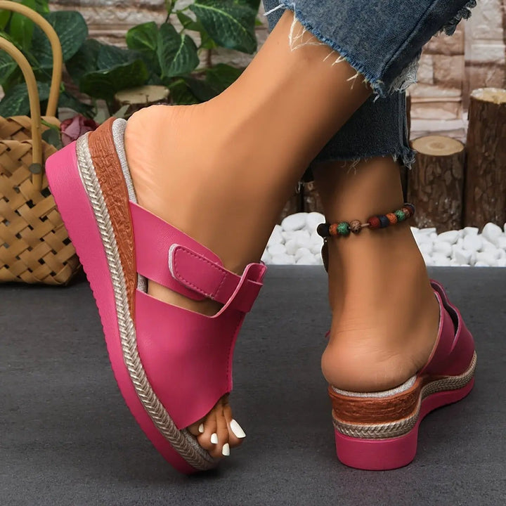 Red open-toe wedge sandals with velcro fastening and woven platform sole